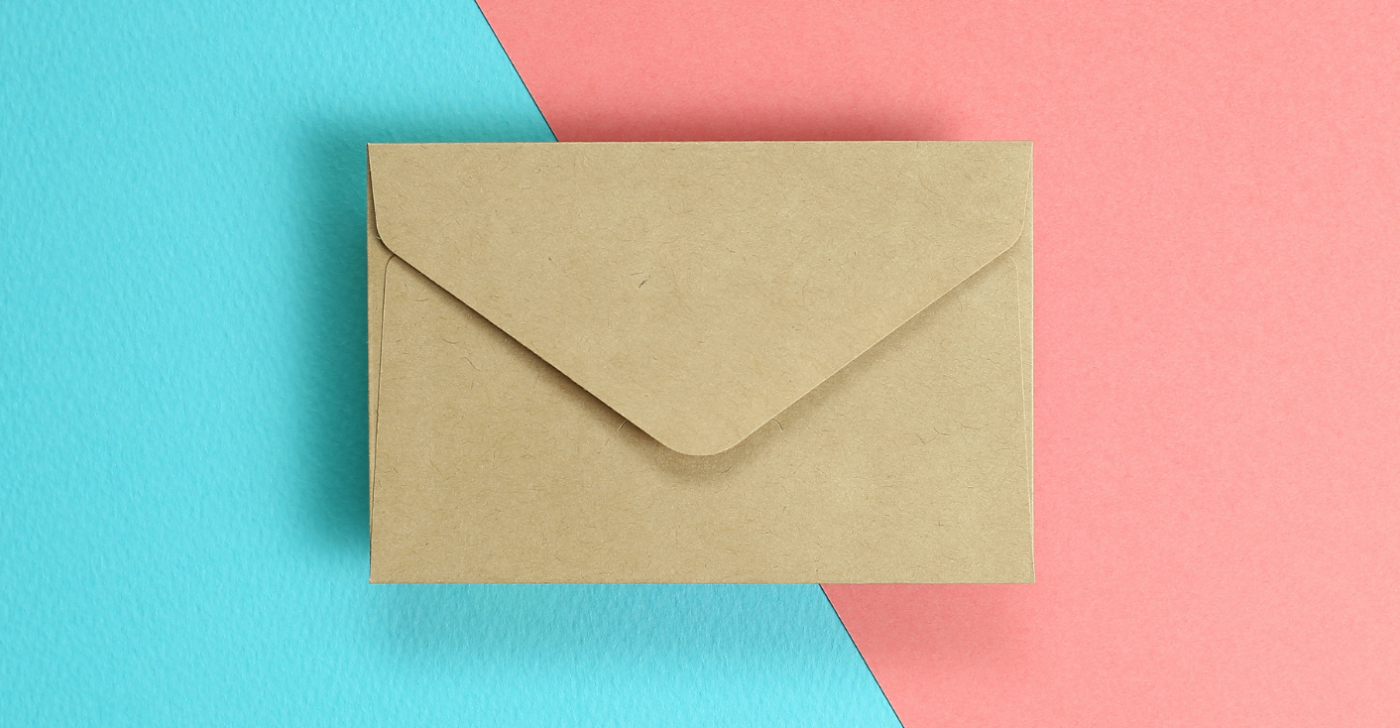 On a bright blue and pink background a beige envelope is centrally displayed to represent how to write effective emails.