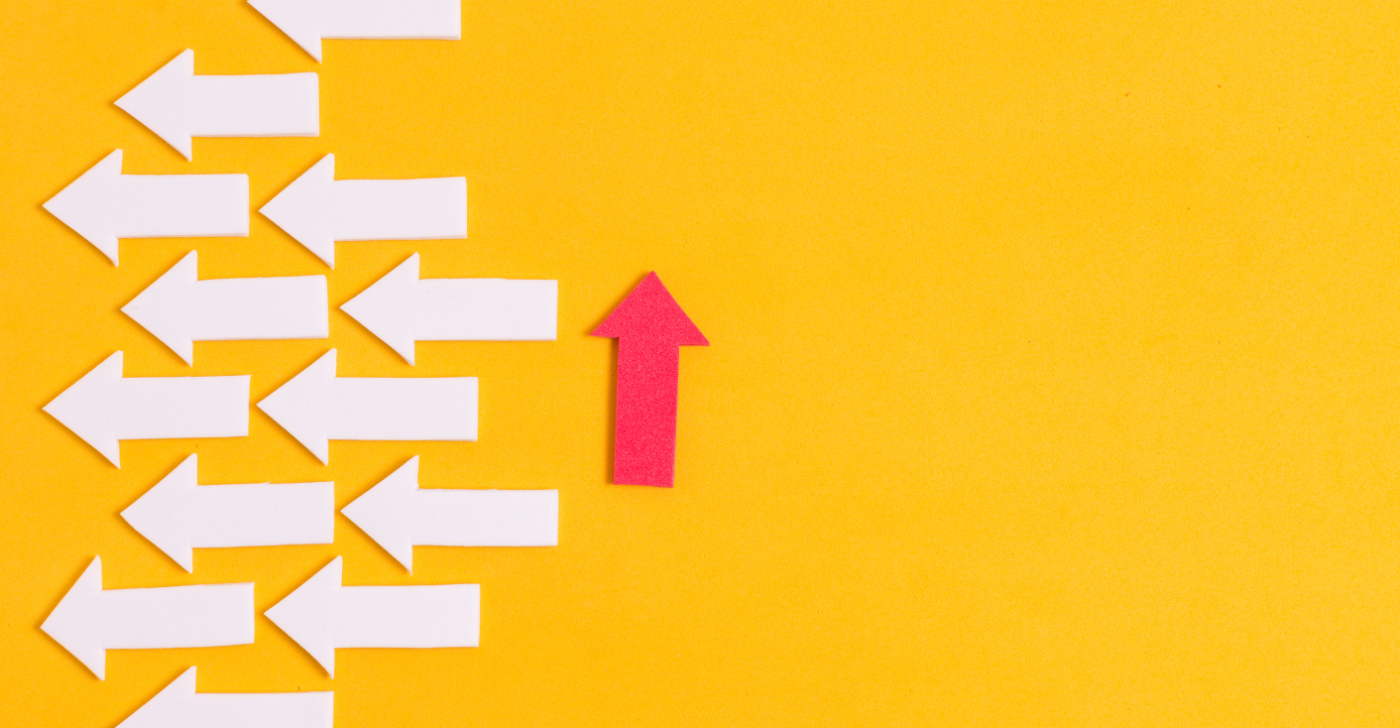 On a yellow background, lots of white arrows point to the left while a singular red arrow points upwards to symbolize how to improve content lifecycle.