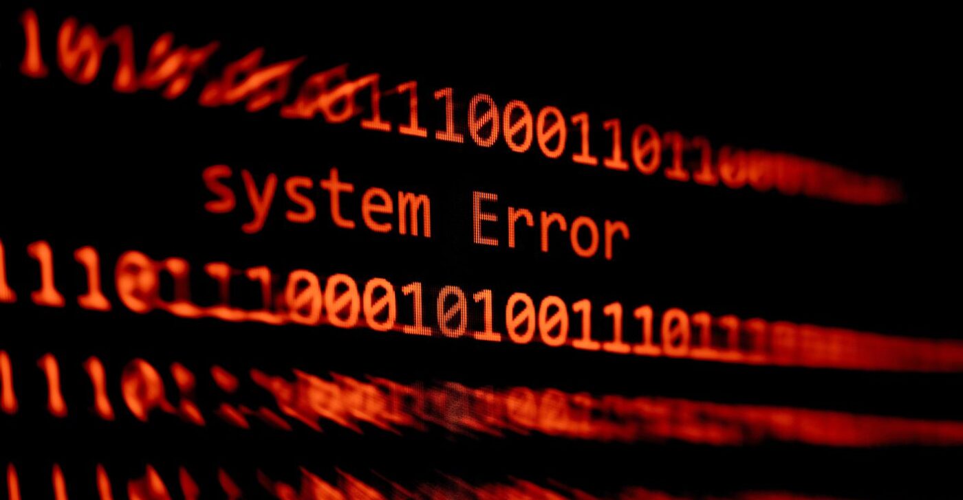 A "system error" message is displayed alongside lines of code in red on a black background.