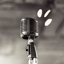 To illustrate a blog about passive vs. active voice, an image of a microphone stands for active voice.