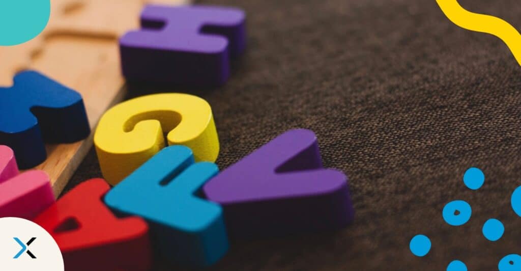 Colorful wooden letters on dark background smybolize grammar guides and style guides.