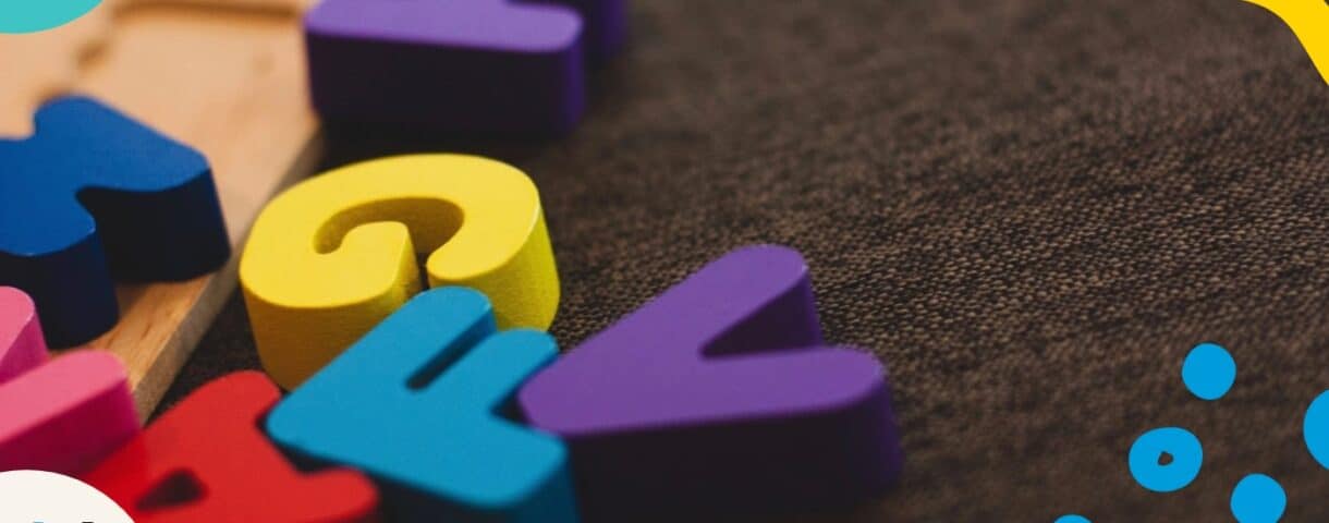 Colorful wooden letters on dark background smybolize grammar guides and style guides.