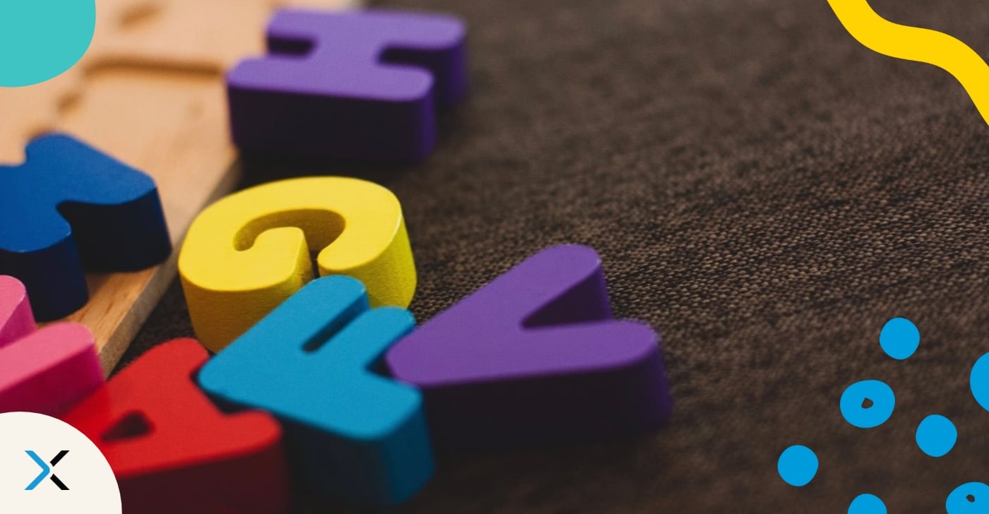 Style Guides vs. Grammar Guides What’s the difference Colorful wooden letters on dark background smybolize grammar guides and style guides.