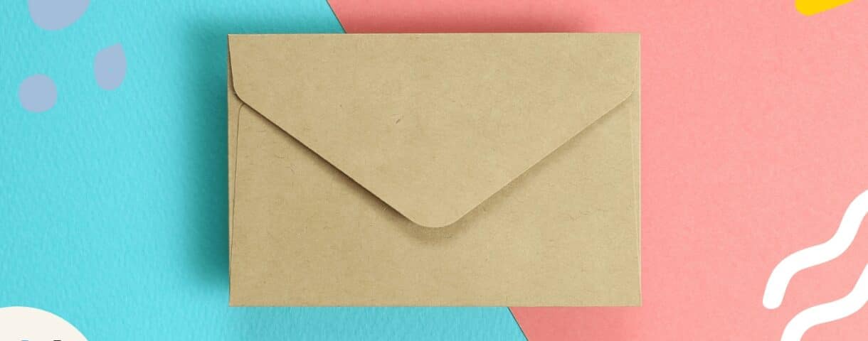 On a bright blue and pink background a beige envelope is centrally displayed to represent how to write effective emails.