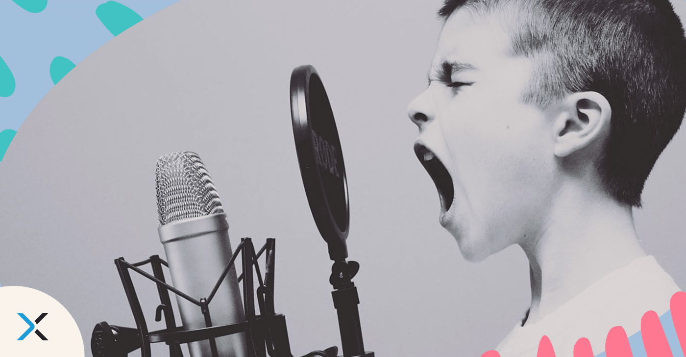 Tone of voice blog A young child testing tone of voice into a microphone