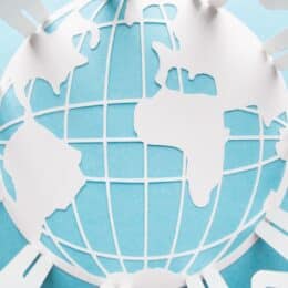 People around a globe symbolize enterprise content governance across global teams.